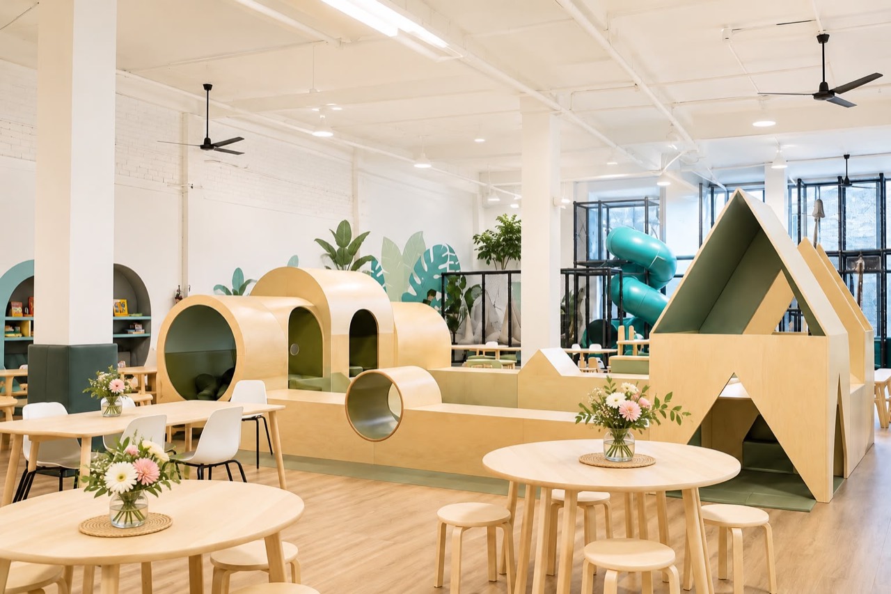 Bright Play Nook venue with café tables, wooden cubbies and play fort